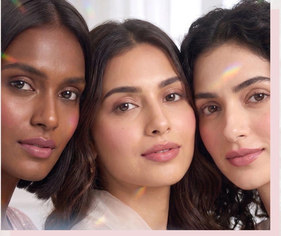Three women, close together, soft studio light